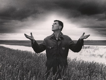 Gavin Kabernick stands hopelessly in his flooded Sanford area wheatfield as the sky threatens more rain, 1968 (PC 18-2258-191)